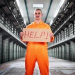 Prisoner holding a sign that says Help
