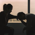 Woman consoling another person