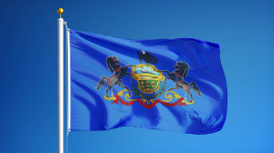 Pennsylvania state flag flying against a blue background