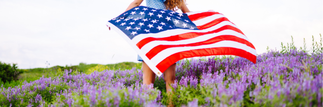 A female holding the American Flag in a field of lavender