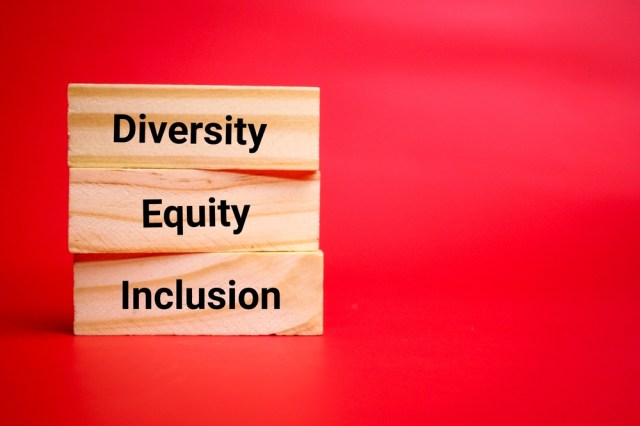 wooden board with the words Diversity, equity, inclusion. the concept of business education