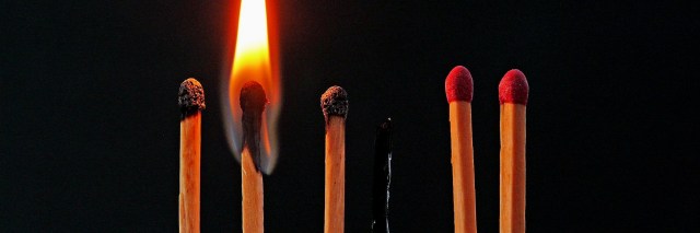 Close up image of a burning match