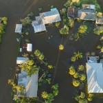 Surrounded by hurricane Ian rainfall flood waters homes in Florida residential area. Aftermath of natural disaster
