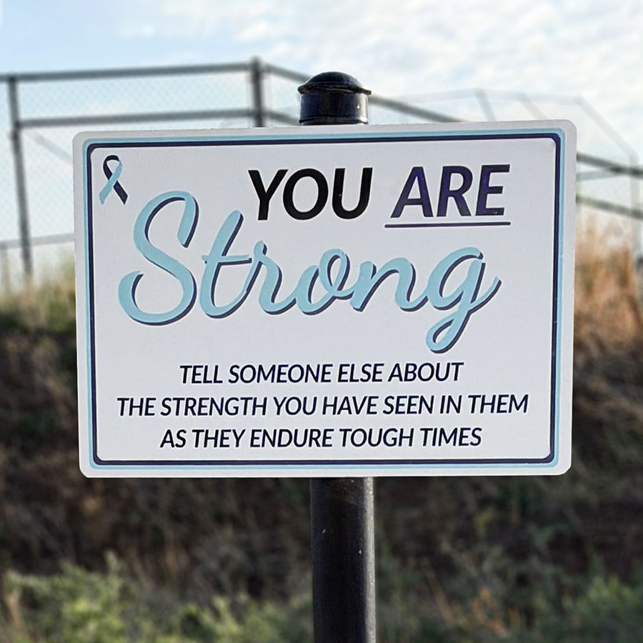 A trail sign that says, "You are strong. Tell someone else about strength you have seen in them as they endure tough times"